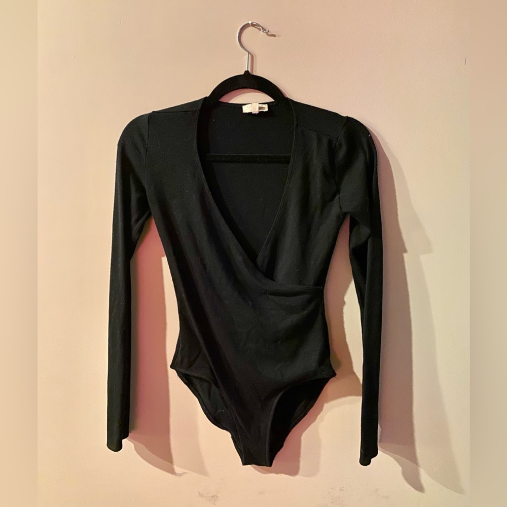 Long-Sleeve black plunging neckline body suit.